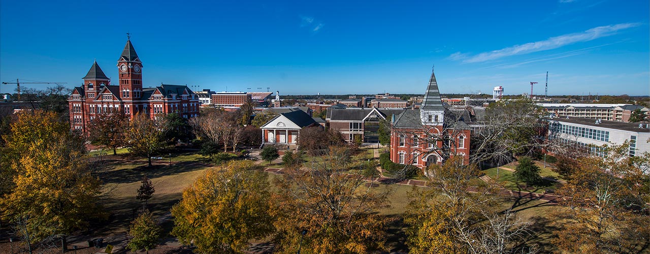 Three students walk through campus.