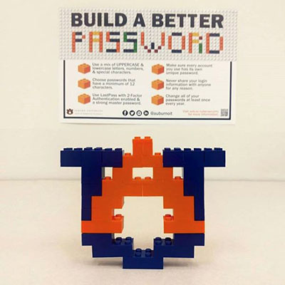 The Auburn Logo made from building blocks in front of the 2019 poster for cybersecurity month