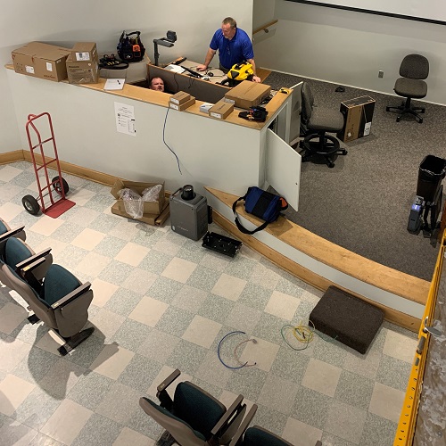 Members of the MMCD team performing upgrades in a Haley Center classroom