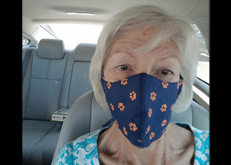 Woman wearing orange and blue face mask