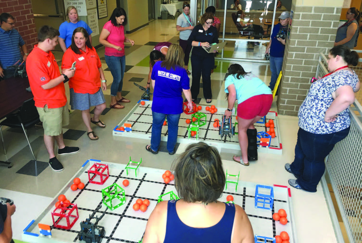 Group of people playing game with objects on tiled floor