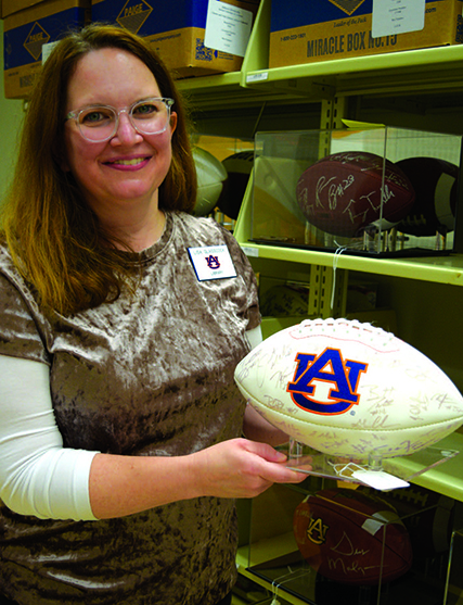 Woman holding signed Auburn football