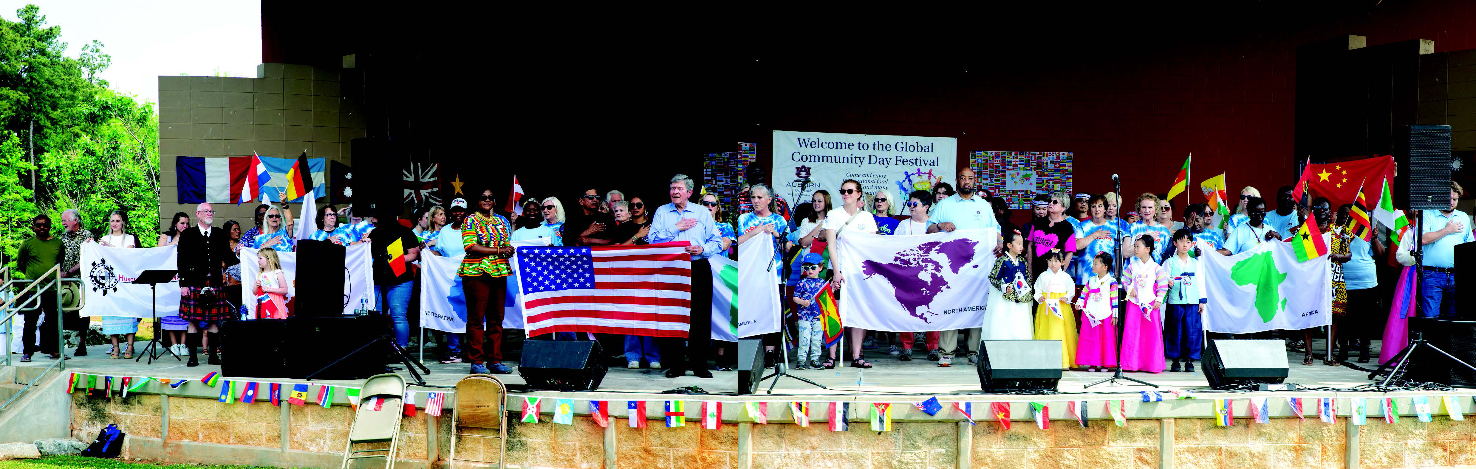 Members attending Global Community Day Festival on stage.