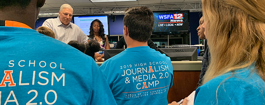 Blue shirt that says Journalism camp