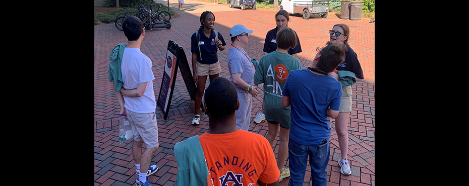 3 female outreach ambassador students share stories with a small tour group of male and female young adults