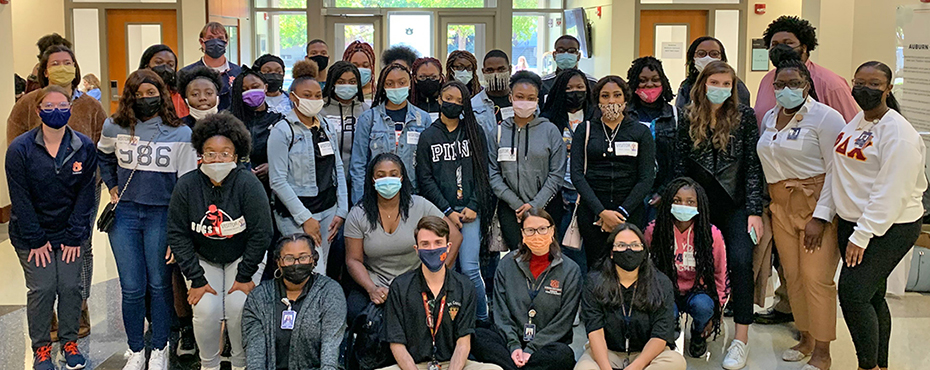 Group photo of students in the lobby of the Auburn University Harrison School of Pharmacy