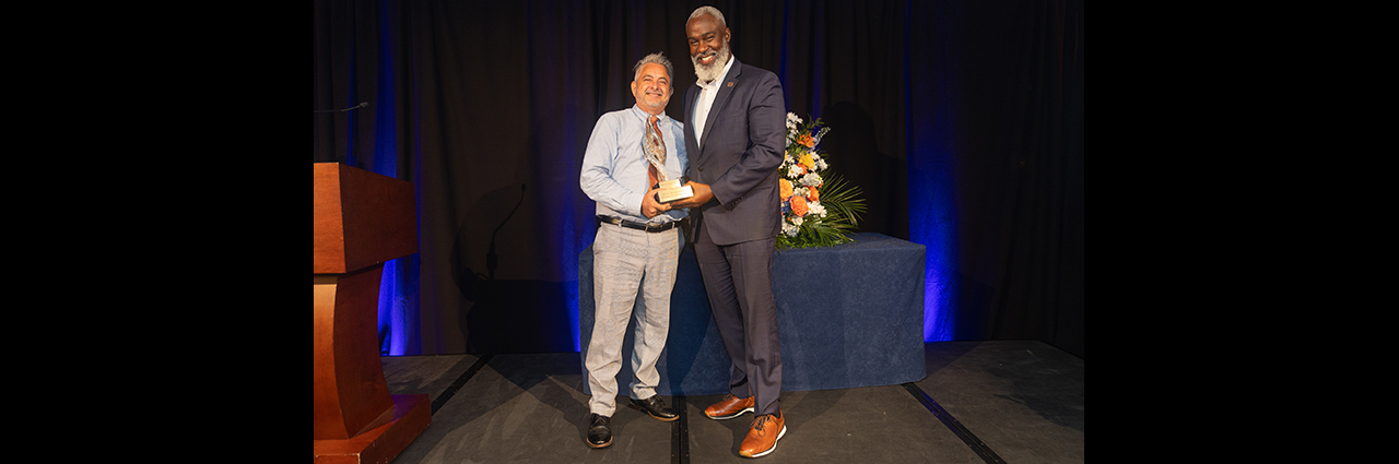 Dr. Cook presenting award to Sean Forbes