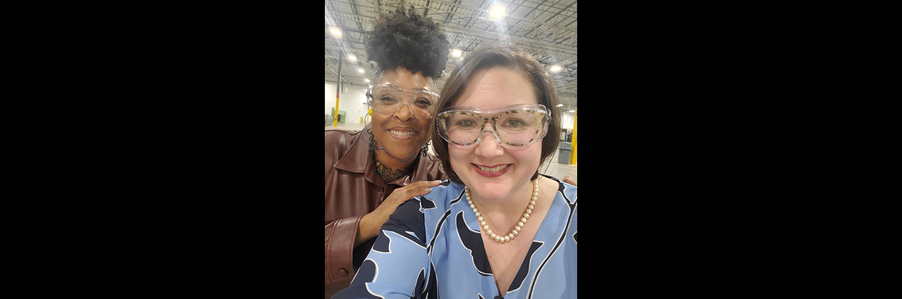 Two female event attendees wearing protective eyeware.