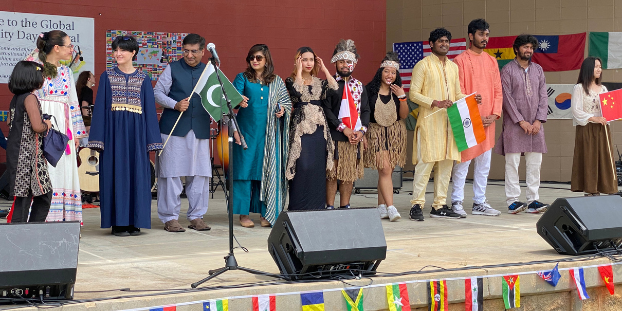 Participants on stage wearing cultural attire