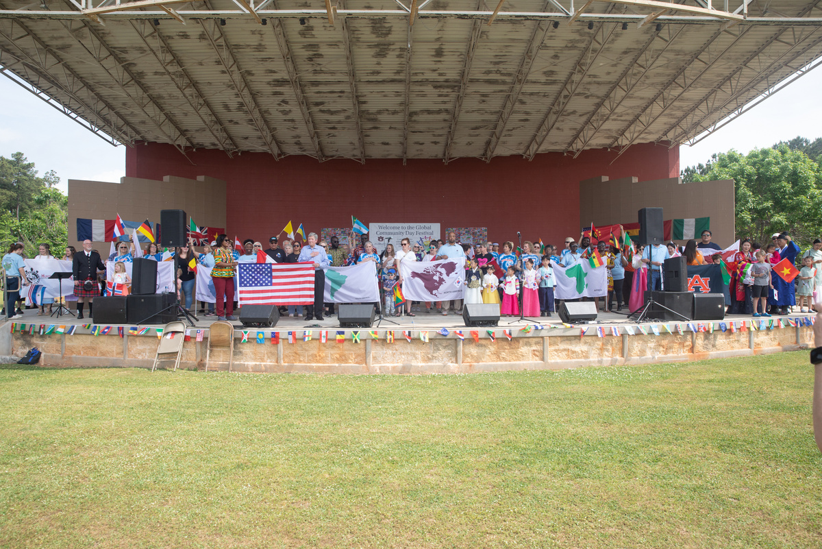 Participants on stage holding flags