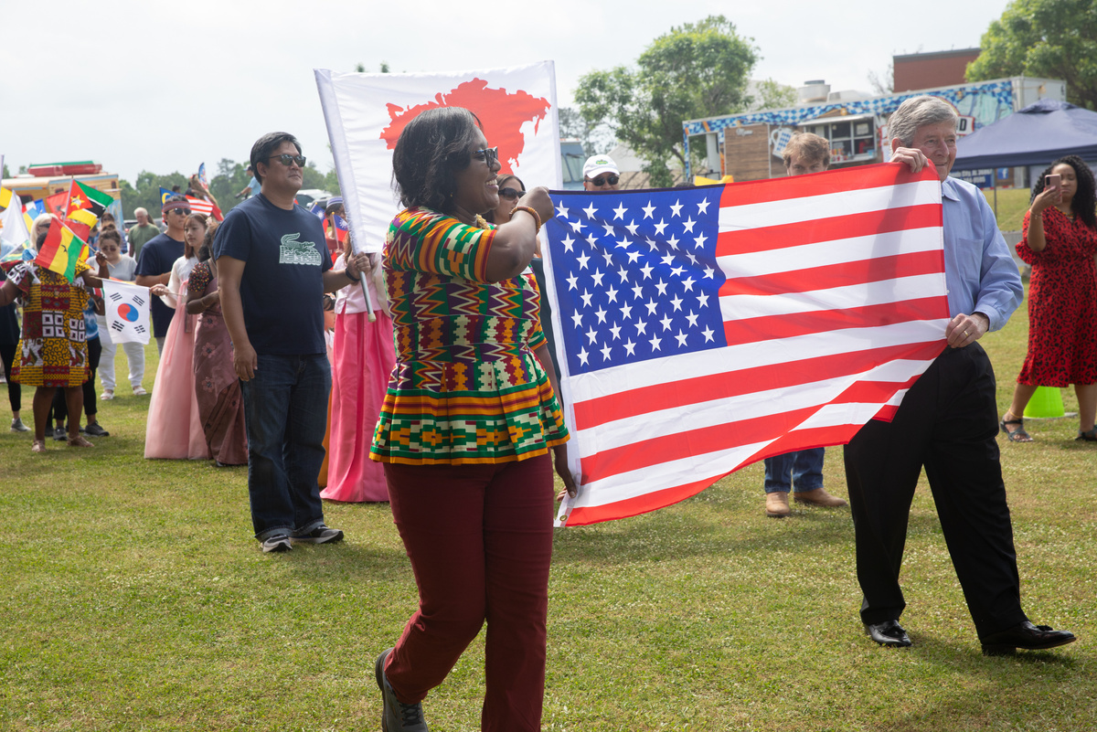 Participants in parade carrying United States flag