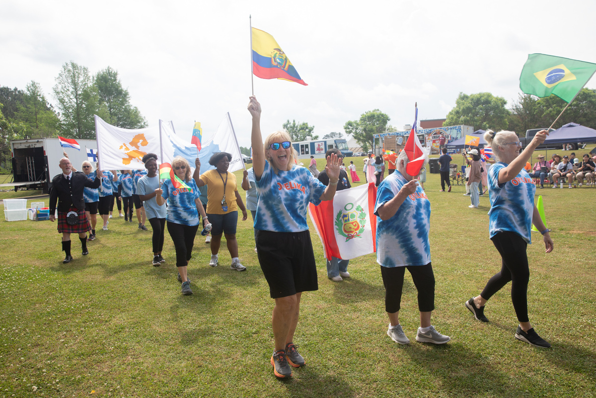 Participants in parade waving flags from many countries