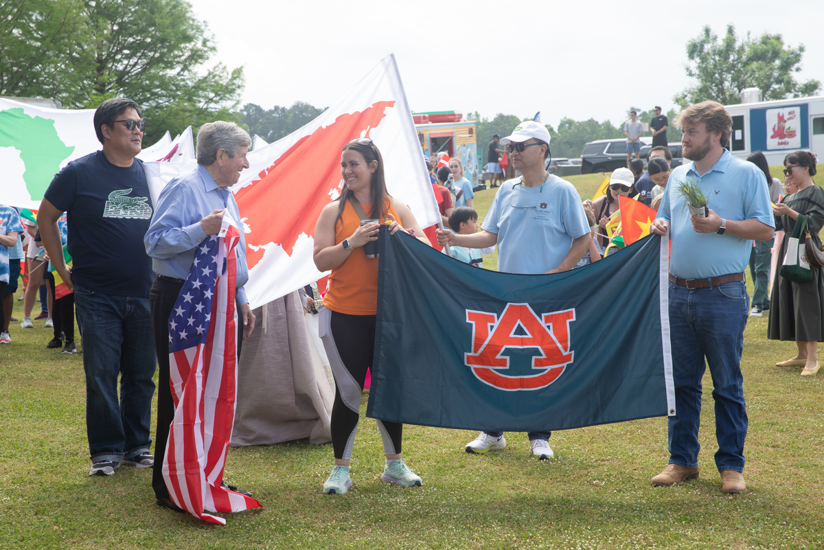 Participants holding Auburn University flag