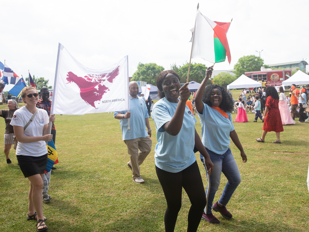 several participants in the parade waving flags