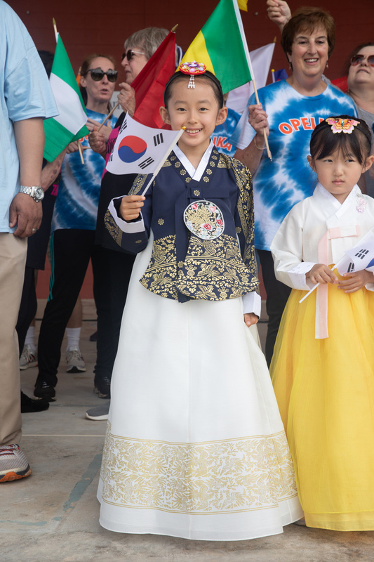 two girls on stage wearing cultural attire