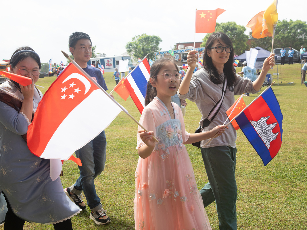 participants in parade waving multiple flags