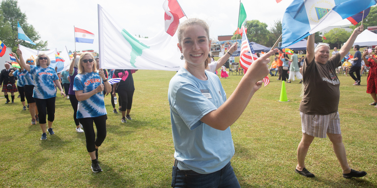 participants in the parade waving a variety of flags