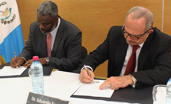 Dr. Cook signing MOU