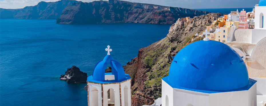 Greek coastline with blue and white cupolas along shore