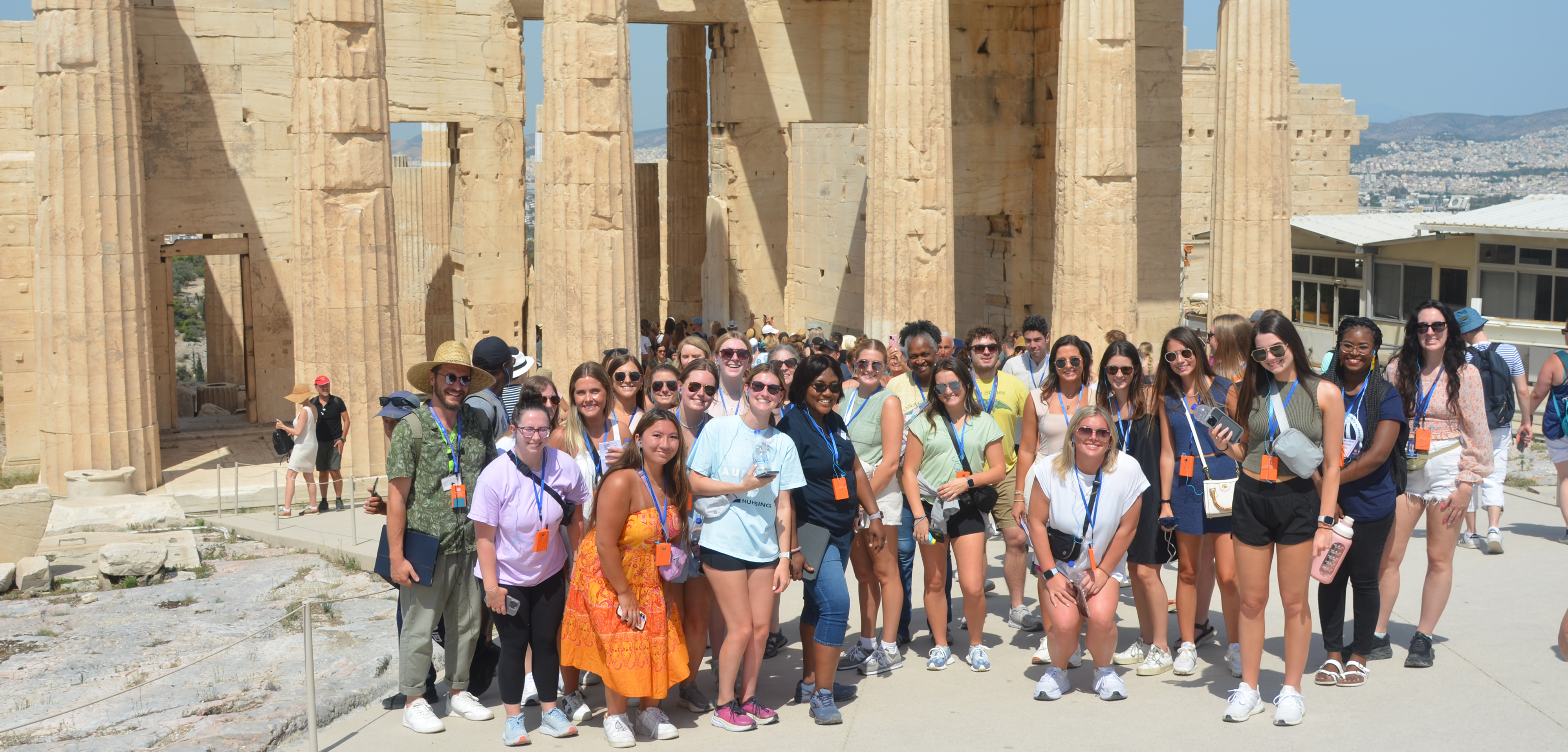 Group of students and faculty advisors standing in front of the Acropolis