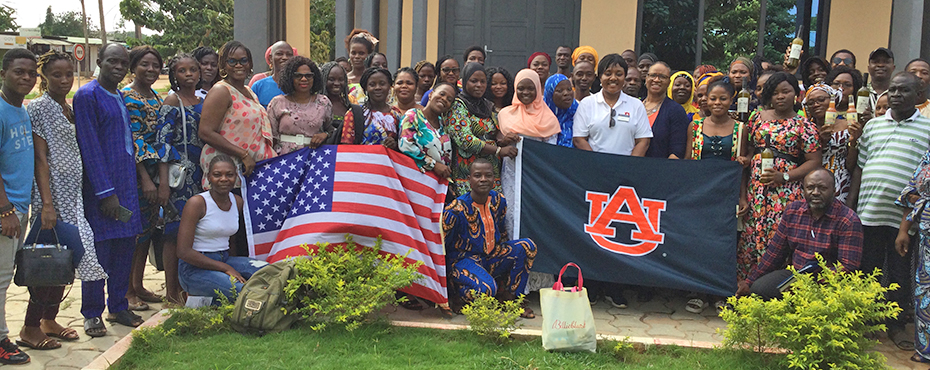 Group photo of class participants holding american flag and AU flag
