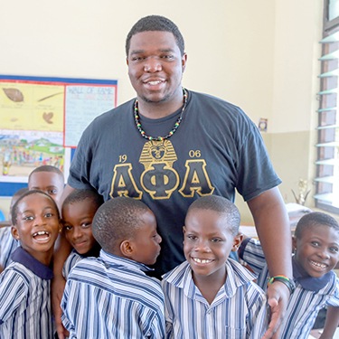 An Auburn student, Khalil Johnson, poses with Ghanian students during Spring Break trip to Ghana, Africa