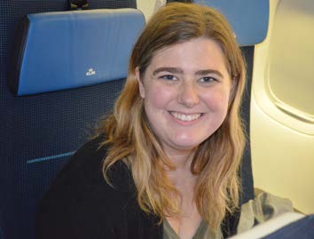 Megan smiles for the camera while in her seat on the airplane