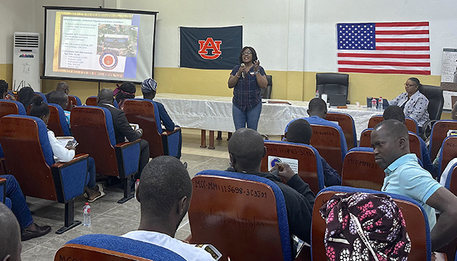 Woman speaking in front of a classroom