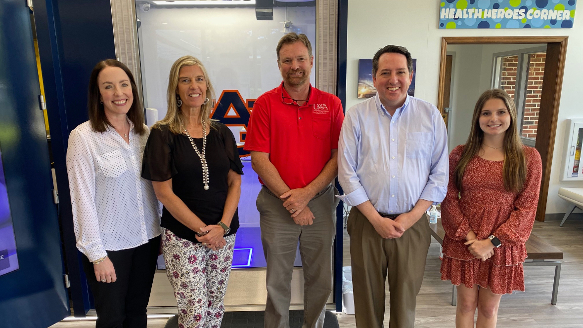 Caroline Straton, Rodney Granec, and Christopher Theriot from UWA along with Hollie Cost and Mikailie Caulder from Auburn University standing in front of the Chambers County OnMed Care Station