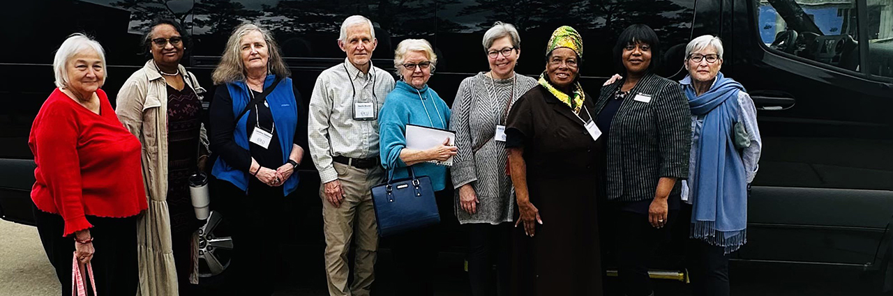 OLLI members posed for a picture in front of the Outreach van during their field trip to Africatown.