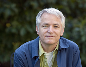 Billy Renkl, man with white hair and a slight smile wearing a blue jacket and green shirt