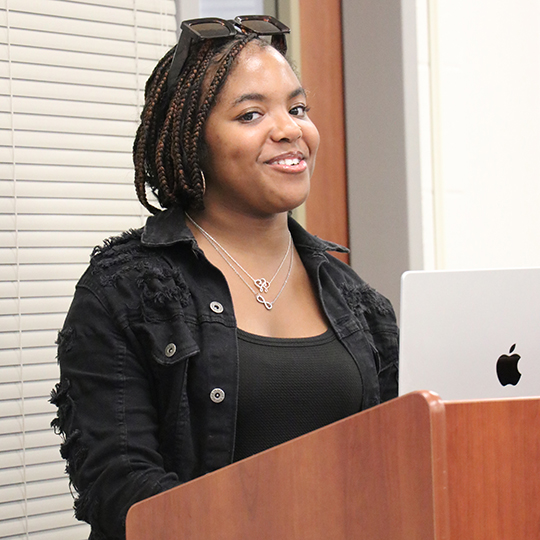 Female standing at a podium