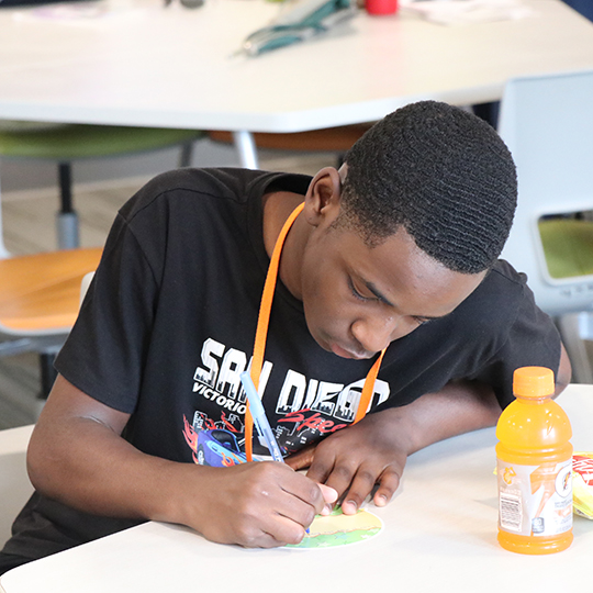 Male student working on a drawing.