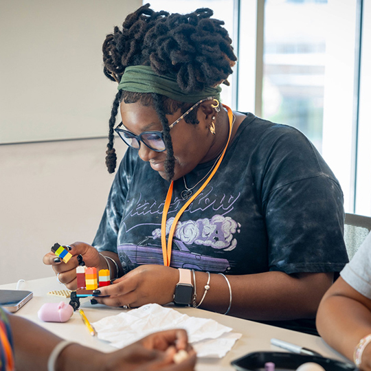 Female student putting together Legos