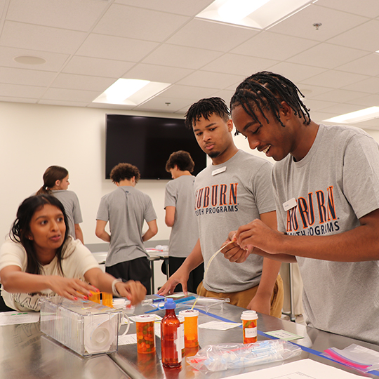 Students labeling medicine bottles.