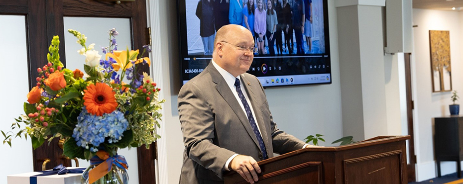 Dr. Dr. Chris Roberts, President Auburn University giving welcoming remarks while standing at a podium.