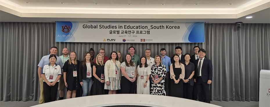 Group photo of men and women participants standing under banner which reads Global Studies in Education - South Korea