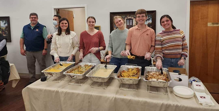 Campus Kitchen students serving food to Ease House