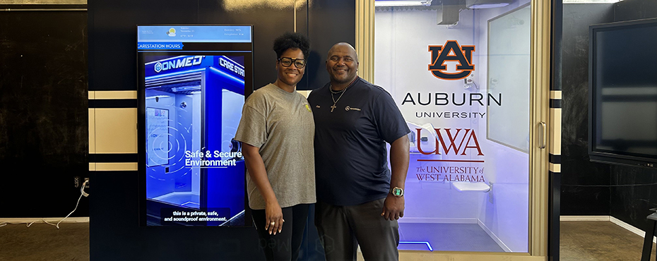 The Mayor of Akron, Christopher Rollins and Demetra Rollins posing in front of the newly installed Care Station in the Akron Public Library, inHale County