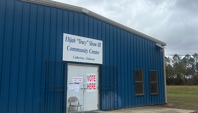 Exterior view of the Elijah Tracey Shaw III Community Center in Catherine, Wilcox County, Alabama, a light-colored building with a welcoming entrance surrounded by greenery.