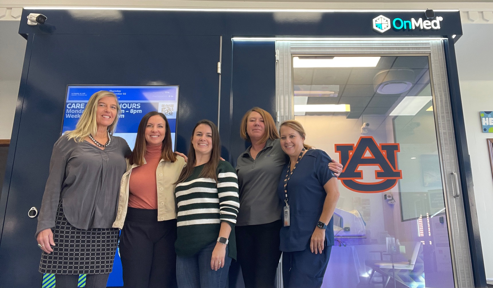 Extension Coordinator, Rachel Snoddy, accompanied by Auburn University and OnMed Staff standing in front of the new OnMed Care Station in Chambers County