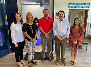 Caroline Straton, Rodney Granec, and Christopher Theriot from UWA along with Hollie Cost and Mikailie Caulder from Auburn University standing in front of the Chambers County OnMed Care Station